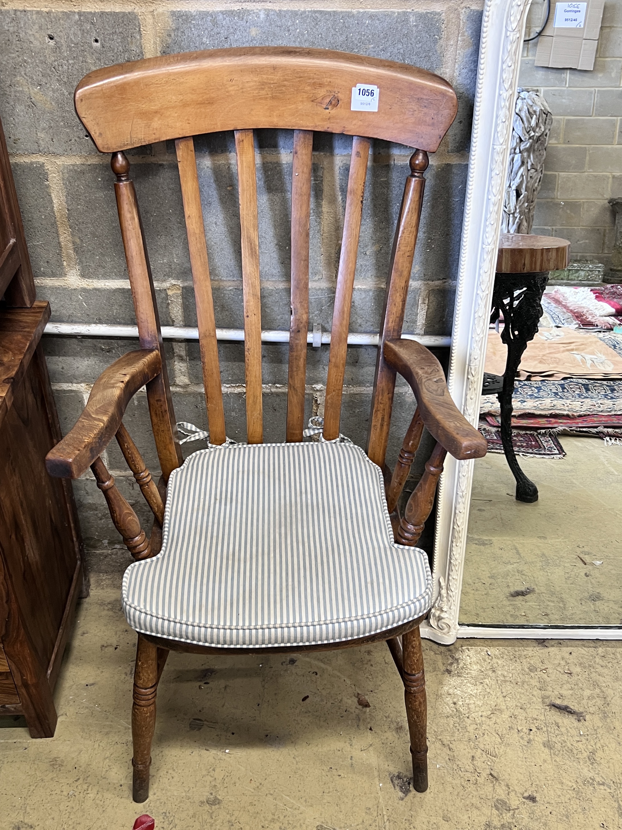 A late Victorian white painted pier glass, width 60cm, height 141cm and a Victorian lathe back Windsor armchair